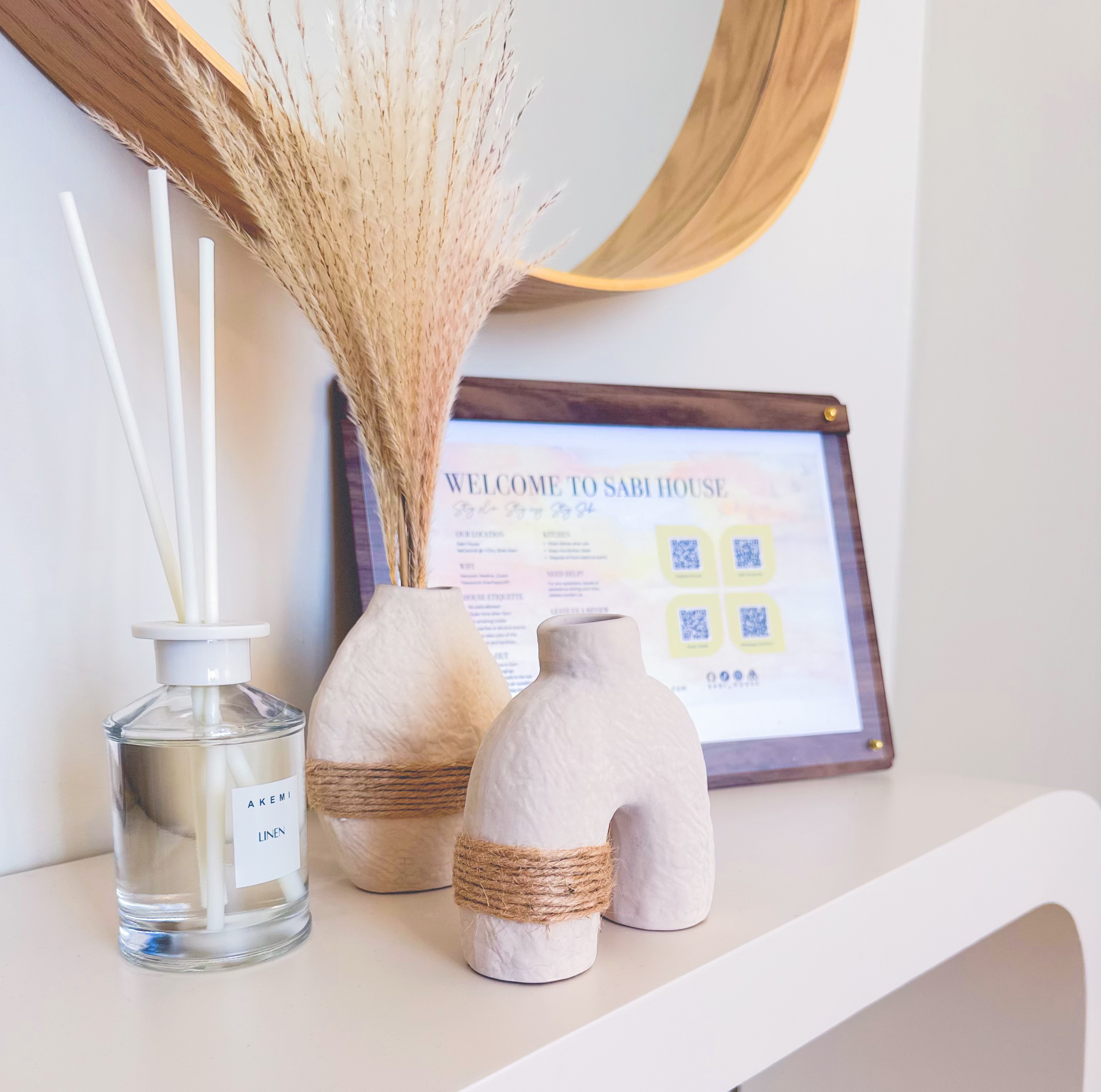 Console table with welcome sign at Sabi House