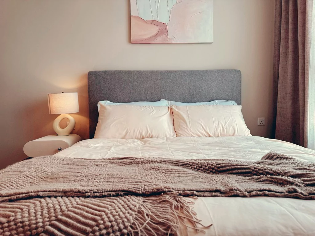 Sabi House Serenity Room with floating queen bed and warm earthy interior